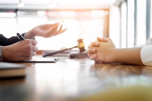 A Nueva York City motorcycle accident lawyer reviewing a claim with a client.